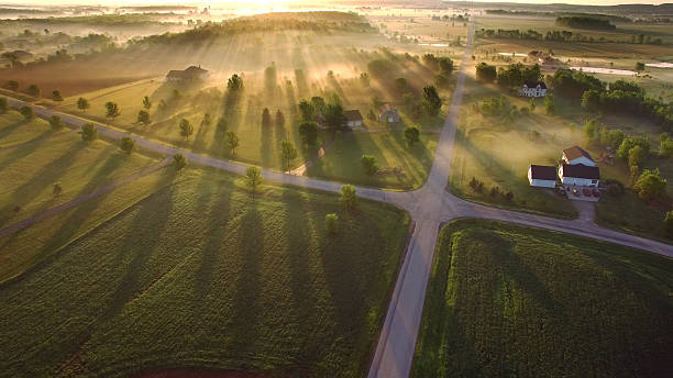 Magical sunrise through ground fog with long shadows and sunbeams.